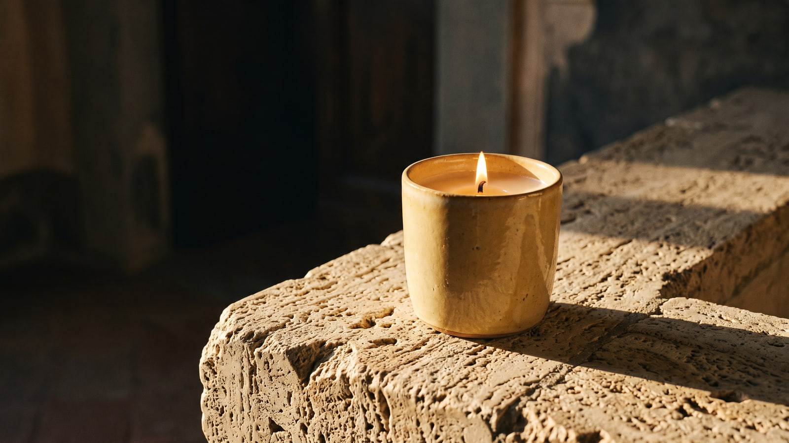 Acqua di Parma style ceramic candle on a Tuscan stone ledge
